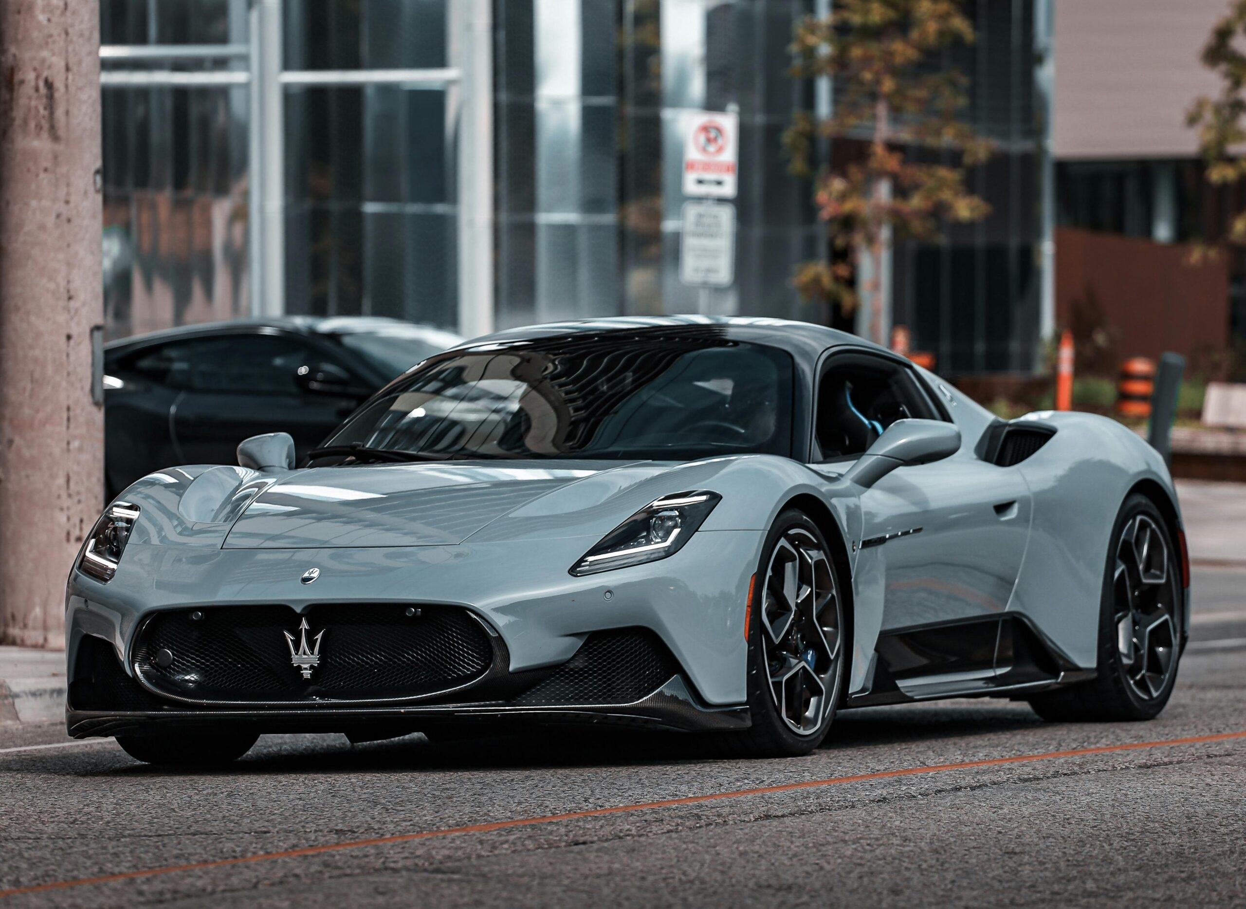 Elegant Maserati MC20 supercar parked on an urban street, showcasing modern luxury.